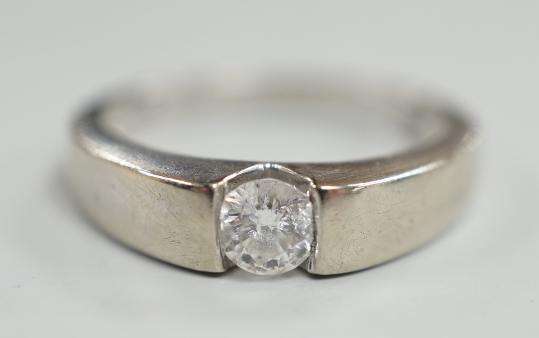 A modern 9ct white gold and solitaire diamond set ring, the stone weighing 0.34ct, size M/N, gross weight 3.2 grams.